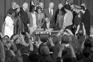 President-Barack-Obama-signs-S-47-Violence-Against-Women-Reauthorization-Act-of-2013-VAWA-grant-programs-Trafficking-Victims-Protection-Act-Gwen-Moore
