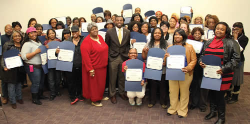 Hillside Resource Center Manager Ann Wilson and Milwaukee County Supervisor David Bowen (center) celebrate with graduates of Make Your Money Talk, a financial education and savings course offered by the Housing Authority of the City of Milwaukee and the Wisconsin Women’s Business Initiative Corporation.