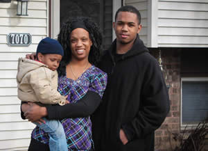 Jerrina McBride and her sons Zyaire and Malik stand proudly in front of their new home, which she purchased with the help of the Make Your Money Talk program.