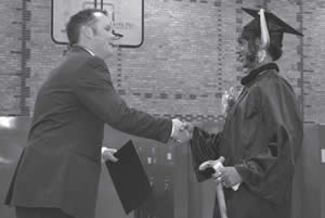 Reanne Brunson receives her GED/HSED certificate from Jake Gorges of SDC Education and Training Program.
