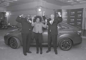 Pictured in Car Winner Photo are (L to R) - Chuck Harvey of Johnson Controls, Linda Stewart of Milwaukee winner of theGive and Win Sweepstakes prize: A NEW 2013 Ford Focus 4-Door Sedan SEL donated by Johnson Controls and Bruce McDonald of Johnson Controls.