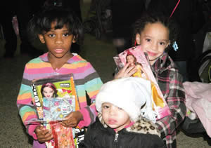 There were gifts and toys for each gender and various age groups the smiles on these girls faces tell the joy shared that day. (Photo by Cy White)