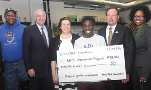 Pictured at the check presentation above from (l-r) are: Will Allen, Growing Power CEO, Mayor Tom Barrett, Bradley Tech teacher, Rochelle Sandrin, Bradley Tech student, Odell Chambers, AT&T WI president, Scott VanderSanden and MPS STEM director, Lena Patton. (Photo by Robert A. Bell)