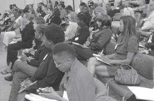 Attendees gathering important information from event (Photo by Robert A. Bell)