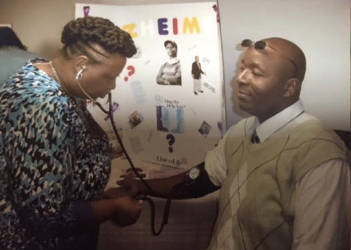 One speaker, Eucita Seals, takes the blood pressure of one seminar attendee. Photo by Venodia Reaves.