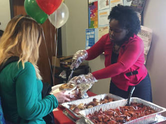 A students gets in line for a holiday meal from Concordia University’s DYF campus. Photo by Ariele Vaccaro.