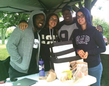 Emman Odofu, Sam Giarratani and Jasmine Velez and Will Sylvester take shelter from the rain at the Increase the Peace Hip Hop Festival . (Photo by Mrinal Gokhale)