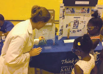 Head Virologist Beth Photenhauer teaches children how easy it is for diseases to spread throughout the classroom. (Photo by Dylan Deprey)