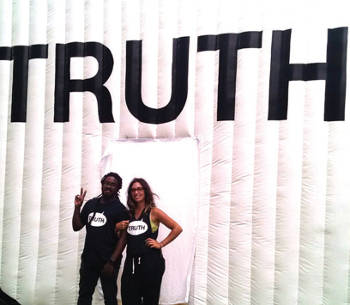 Artist Will Sylvester poses with tour coordinator Sam Giarratani outside the giant Truth Booth. (Photo by Mrinal Gokhale)